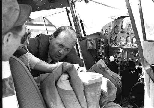 Watched by a curious US serviceman at Goose Bay, Labrador Peter Gluckmann prepares his emergency rubber life raft before flying across the Labrador Sea to US base at Bluie West One (now Narsarsuaq airport) in Greenland. 